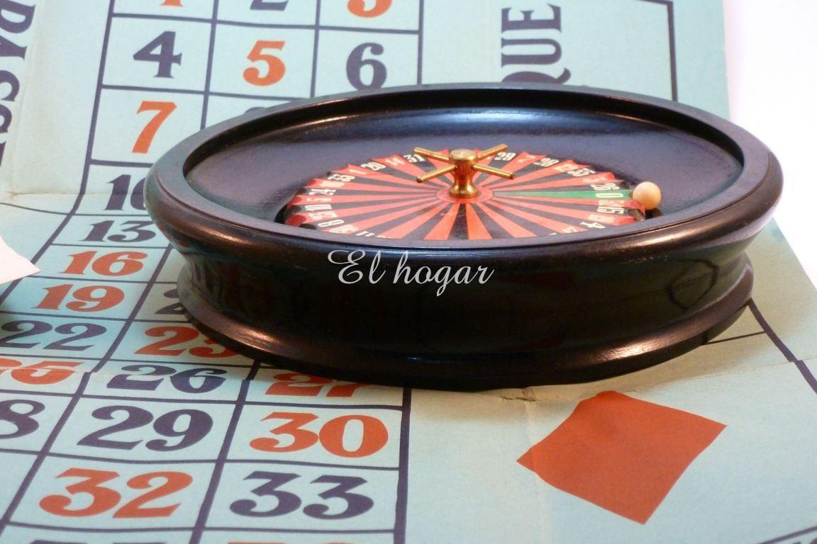 Ruleta de juguete en madera, con tapete de cartón y las reglas del juego